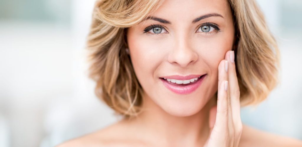 A client showcasing radiant, firm skin after receiving high-quality rejuvenation therapies at a premier med spa.